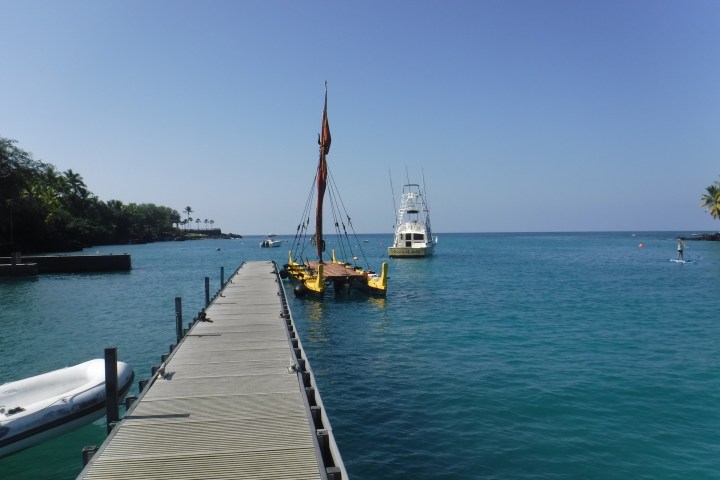 a boat is docked next to a body of water